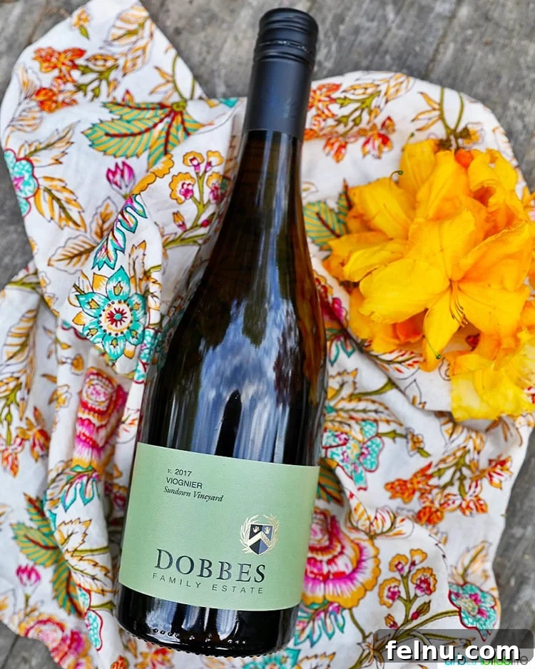 Summer Peach and Tomato Salad 6 A bottle of Dobbes Winery Viognier white wine next to a vase of white flowers.
