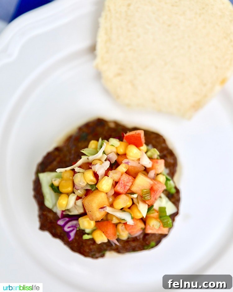 Sun-Kissed Slaw: Peaches, Corn & Tomatoes 6 A burger topped with a generous serving of vibrant summer slaw, showcasing its versatility as a topping.