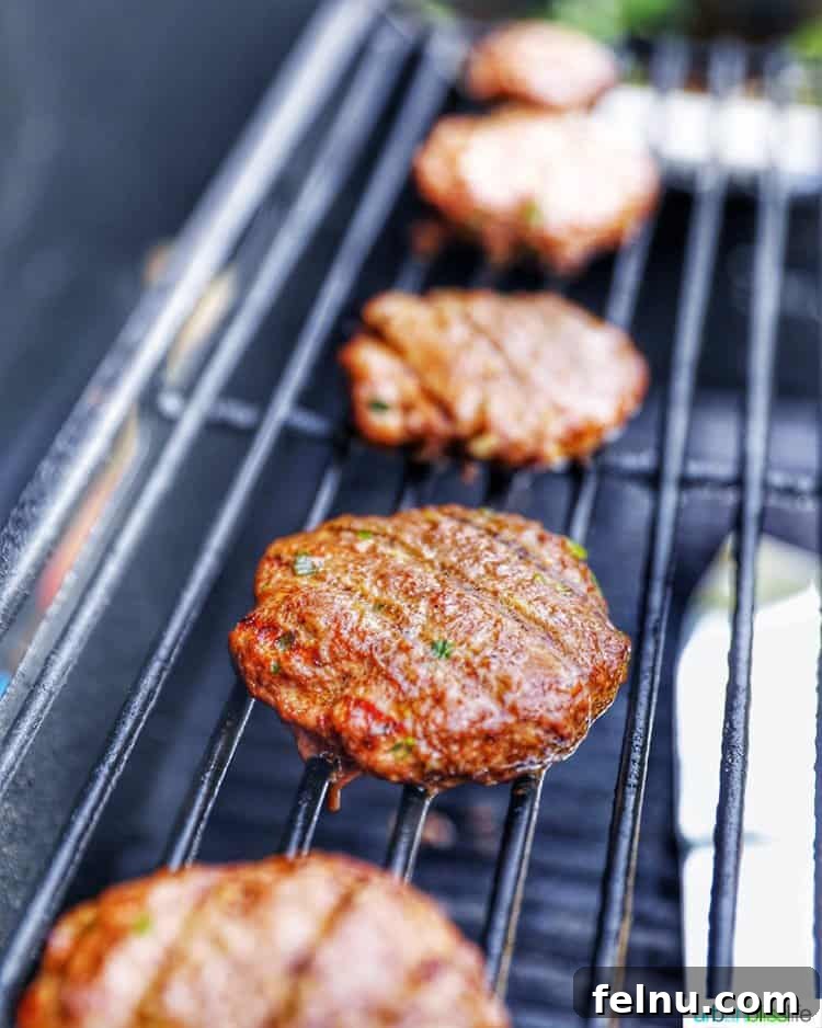 Asian burgers cooking on the grill, sizzling and releasing their delicious aroma.