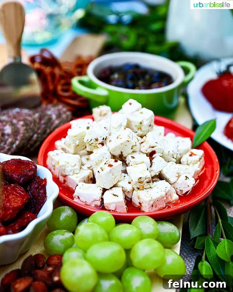 Mediterranean Marinated Feta 2 Marinated feta cheese served on a grazing table with grapes and other accompaniments