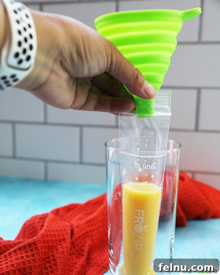 Tequila Sunrise Ice Pops 4 Pouring orange juice into freezer pop bag using a funnel.