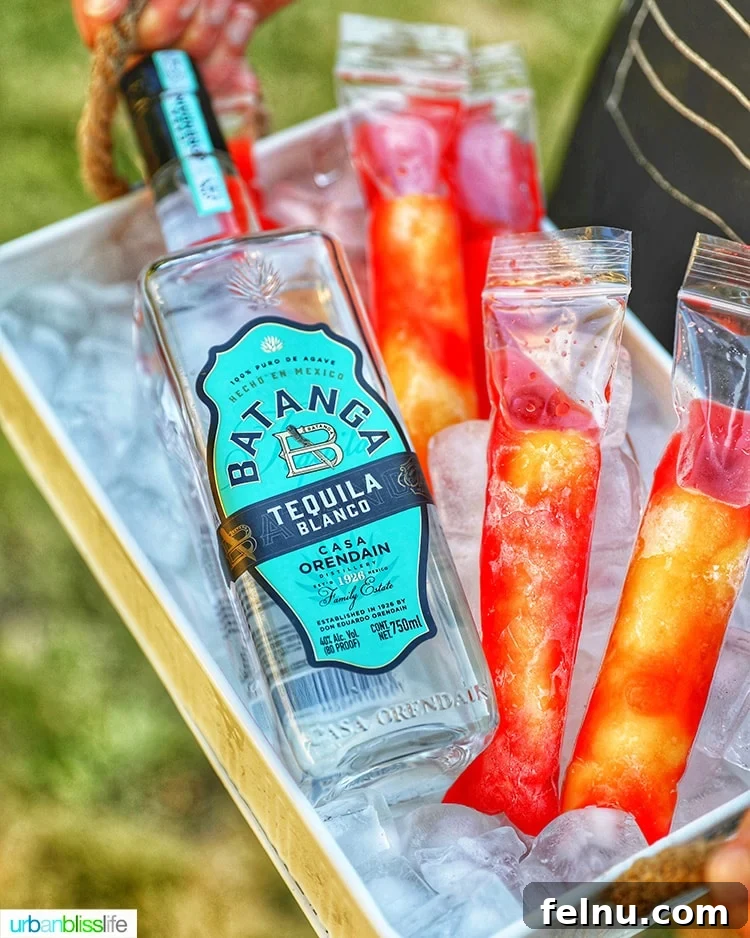 Tequila Sunrise Ice Pops 6 Tequila bottle with Tequila Sunset Popsicles on ice.