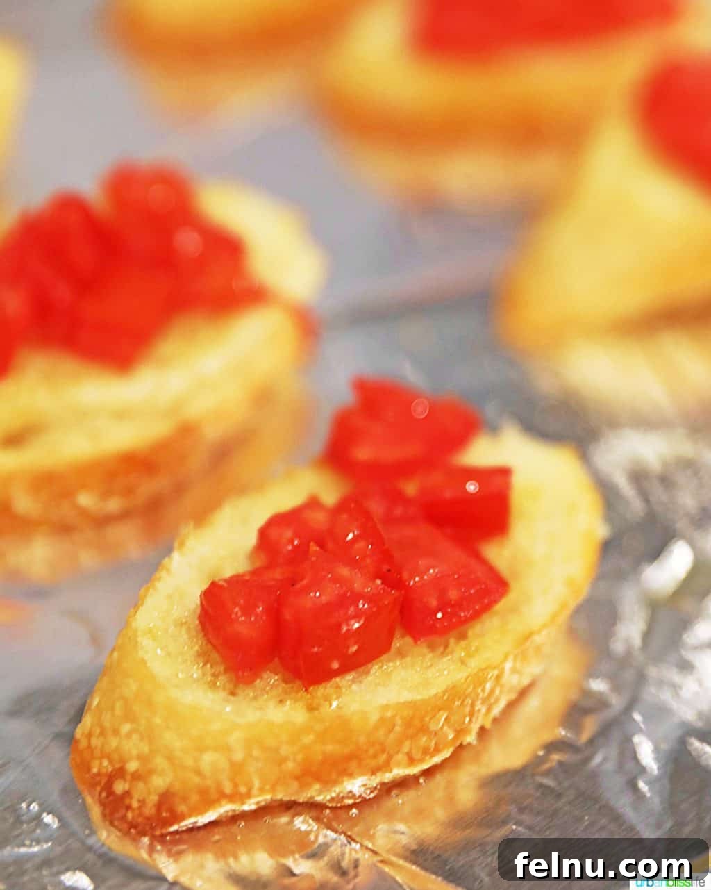 Vine-Ripened Tomato Bruschetta with Balsamic Glaze 6 Baguette slices topped with the tomato mixture, ready for baking.