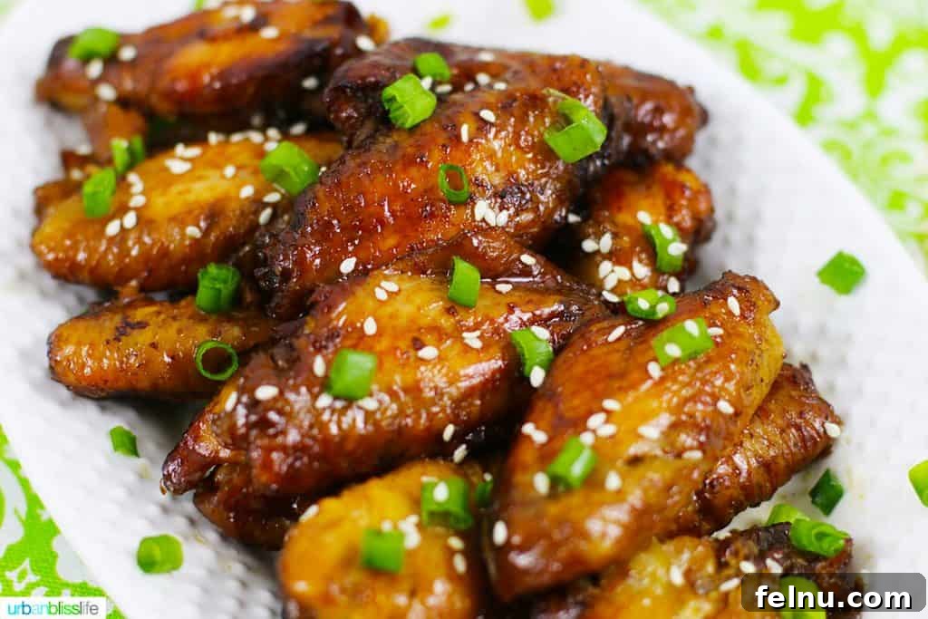 Glazed Teriyaki Chicken Wings 3 A vibrant landscape shot of a plate brimming with golden-brown baked teriyaki chicken wings, inviting and delicious.
