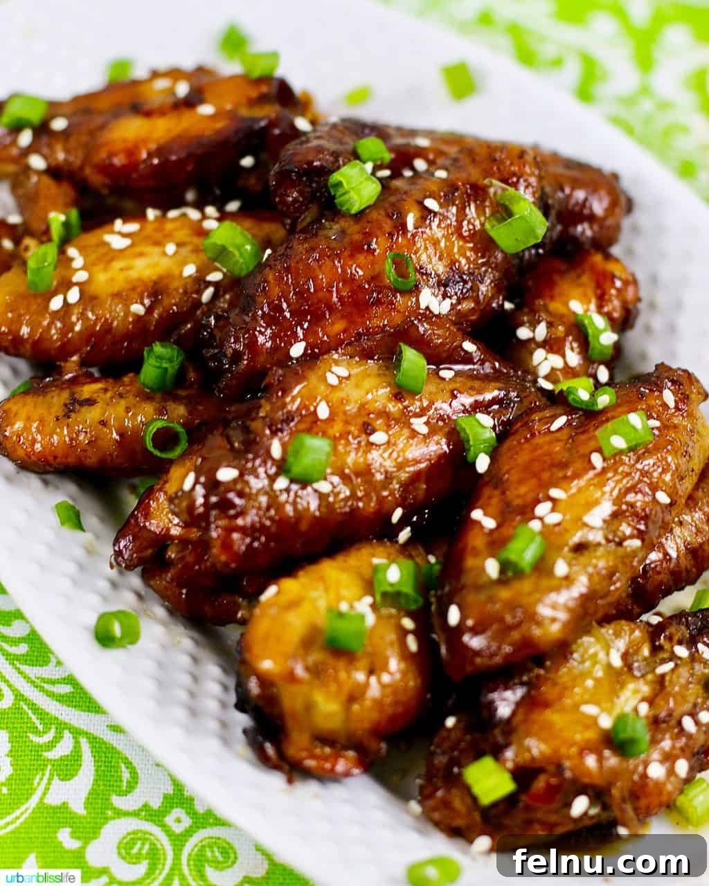 Glazed Teriyaki Chicken Wings 4 A close-up shot of perfectly baked teriyaki chicken wings, golden-brown and glistening with sauce, artfully arranged on a plate.