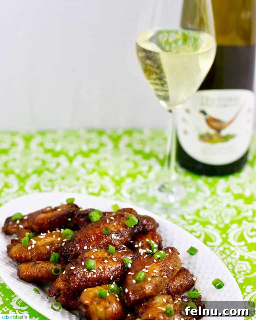 Glazed Teriyaki Chicken Wings 5 A rustic shot of baked teriyaki chicken wings alongside a glass of Teutonic Riesling white wine, embodying a perfect culinary pairing.