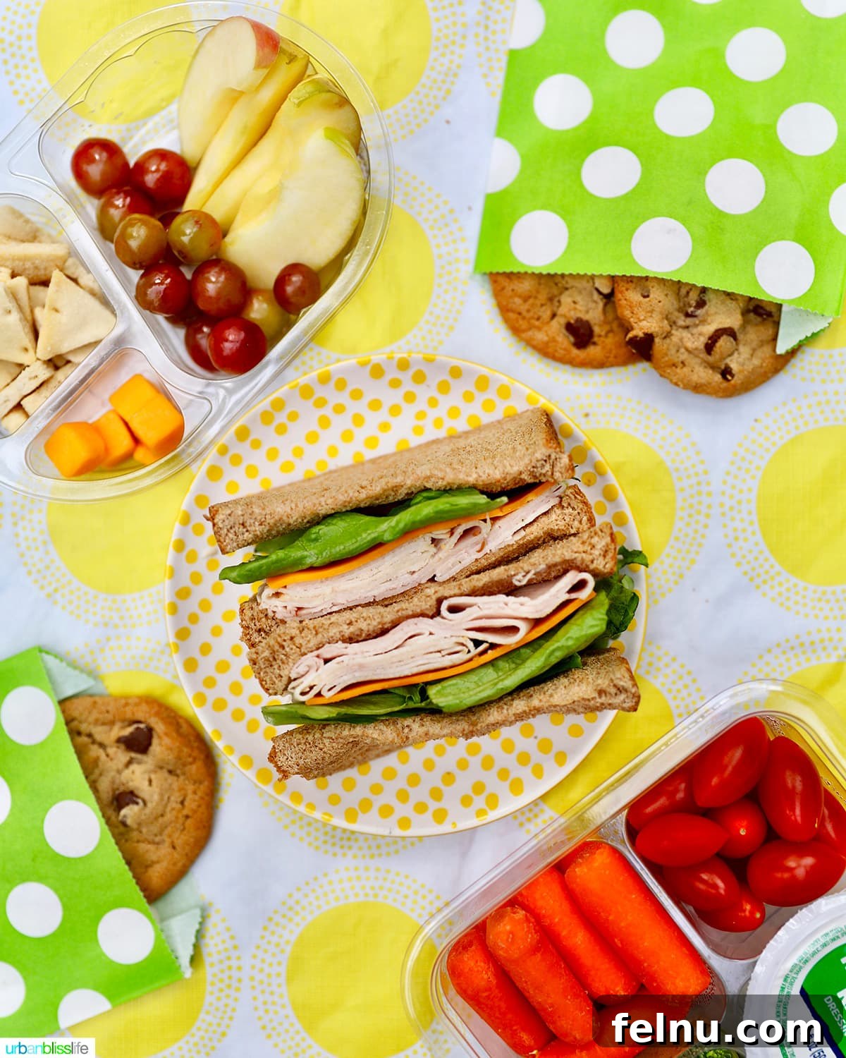 Creative and Nutritious Lunchbox Inspirations 2 Assortment of healthy school lunch items: sandwiches, cookies, cheese, fruit, and vegetables on a yellow and white tablecloth.