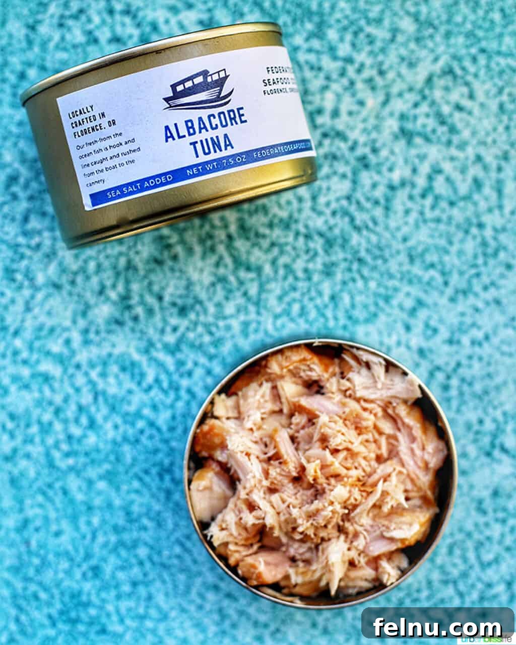 Beat the Heat Dinners 4 Canned albacore tuna on a blue background, a versatile pantry staple for summer meals.