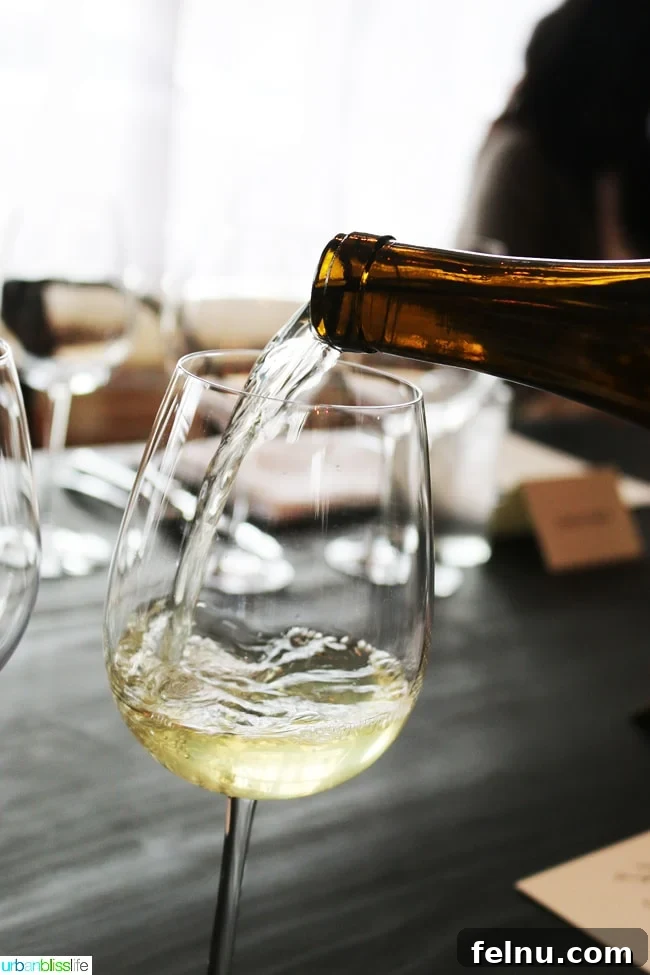 Shrimp Salad Reimagined Keto Paleo Whole30 Perfection 4 Pouring white wine into a glass, perfect for pairing with shrimp salad.