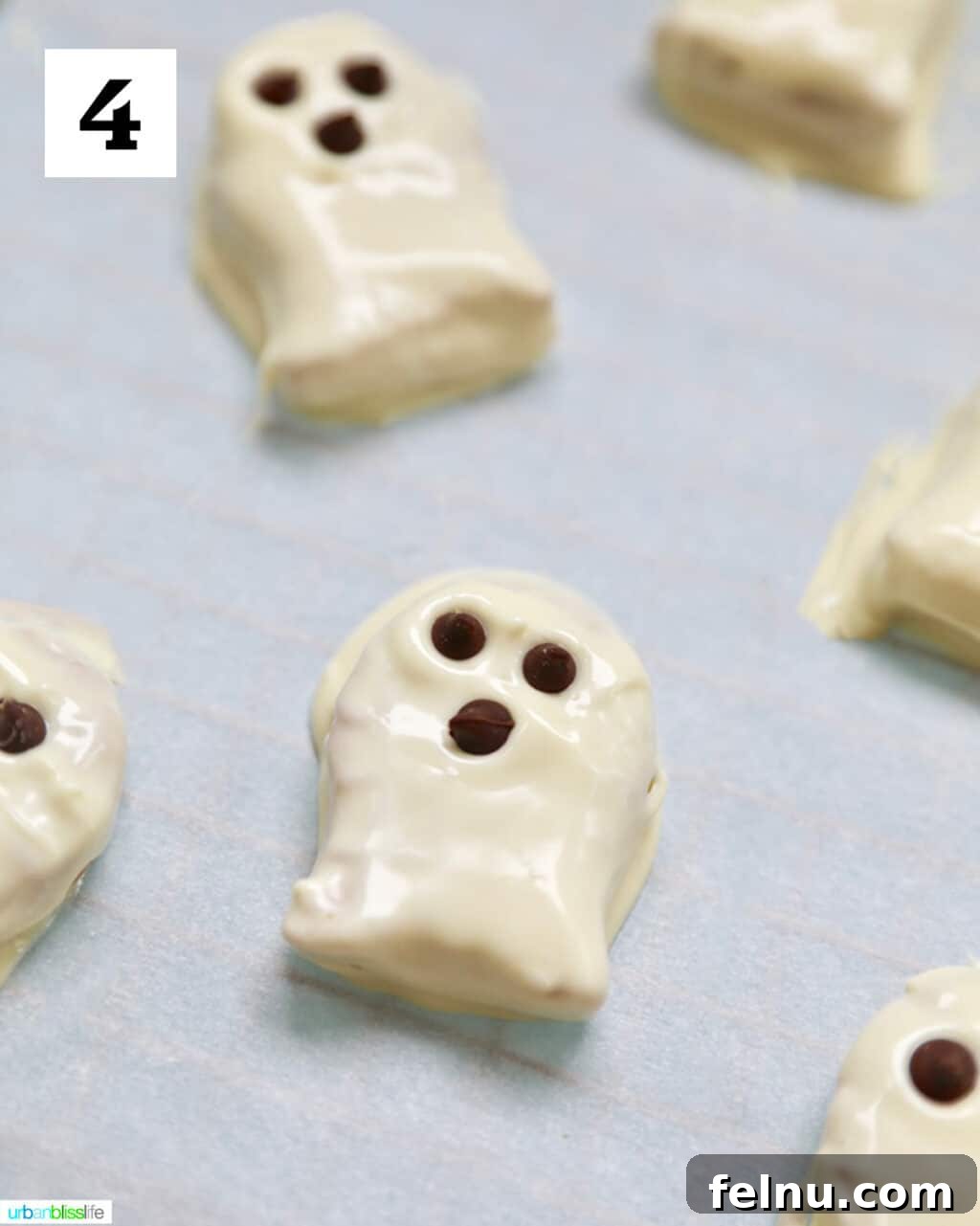 Spooky Nutter Butter Ghosts 8 Nutter Butter cookies dipped in white chocolate with chocolate chips
