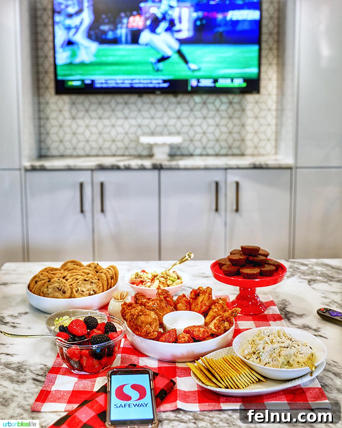 Ultimate Tailgate Grub Guide 3 A close-up shot of a TV screen showing a football game, surrounded by a delectable spread of tailgating food.