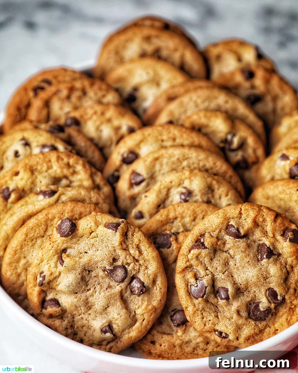 Ultimate Tailgate Grub Guide 7 A tempting close-up shot of a stack of freshly baked chocolate chip cookies, showcasing their golden-brown color and abundance of chocolate chips.
