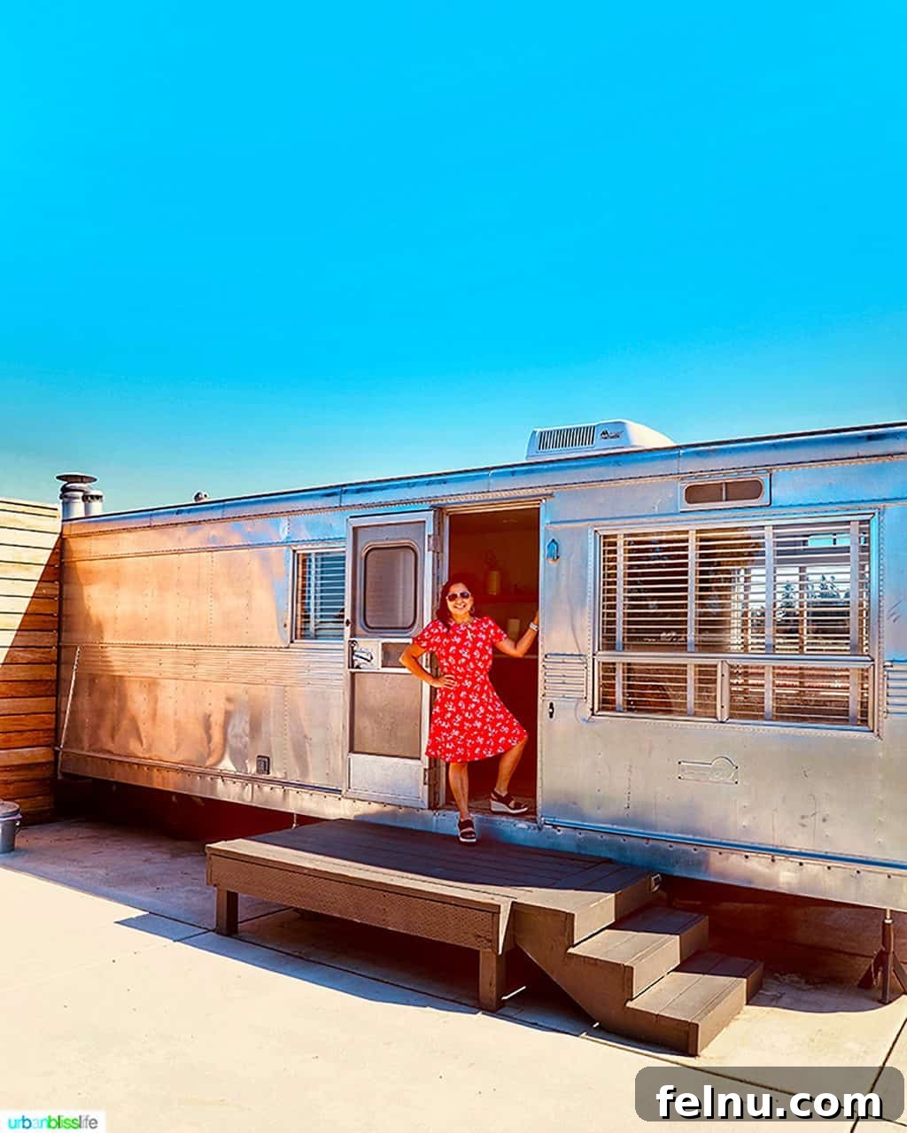 Glamping in Wine Country: Vintages Trailer Resort in Oregon's Willamette Valley 2 Marlynn Schotland stands in the doorway of the elegant 1956 Royal Spartan Mansion airstream at Vintages Trailer Resort, showcasing its vintage appeal and welcoming entrance.