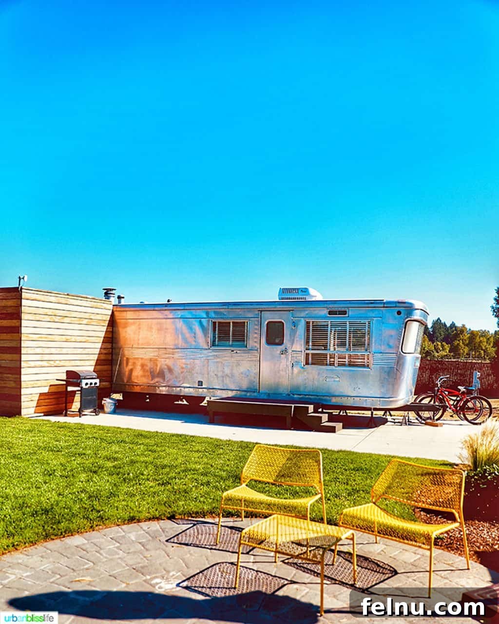 Glamping in Wine Country: Vintages Trailer Resort in Oregon's Willamette Valley 8 The impressive exterior of the 1956 Royal Spartan Mansion airstream at Vintages Trailer Resort, featuring classic lines and inviting yellow chairs for outdoor relaxation.