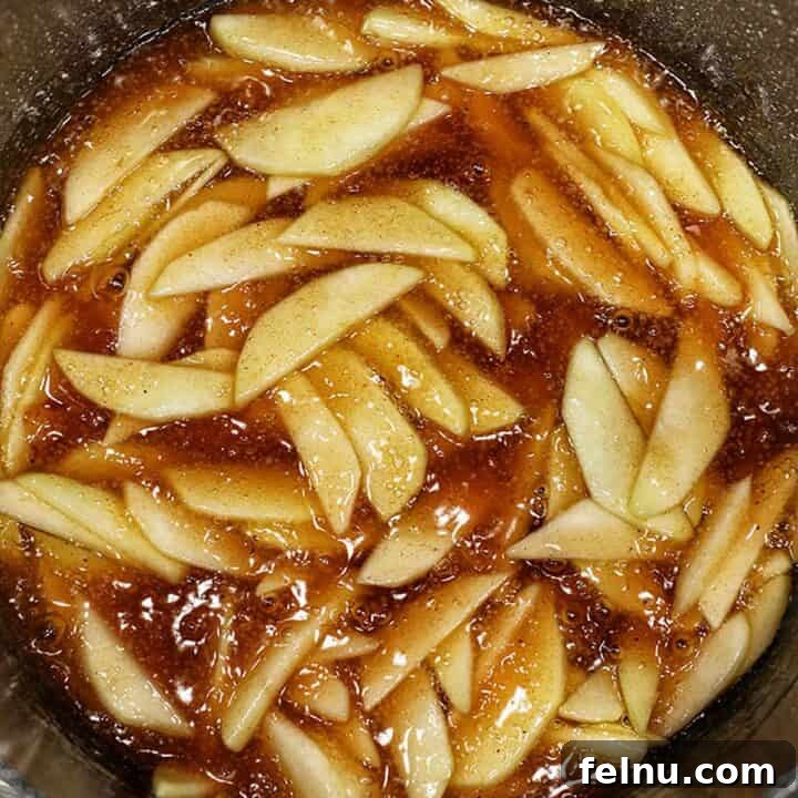 apple pie filling in pan, a close up shot of bubbling apples