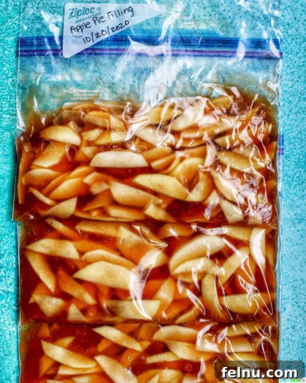 Homemade Freezer Apple Pie Filling 3 Labeled freezer bags filled with homemade apple pie filling, neatly stacked for storage