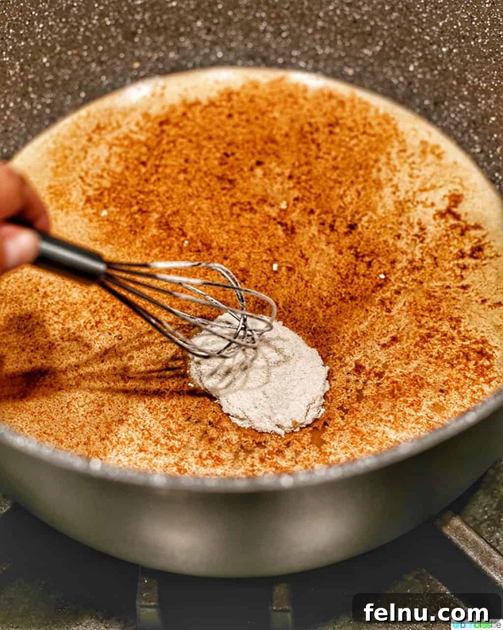 Homemade Freezer Apple Pie Filling 8 Dry spice mixture being whisked into water in a Dutch Oven on the stove