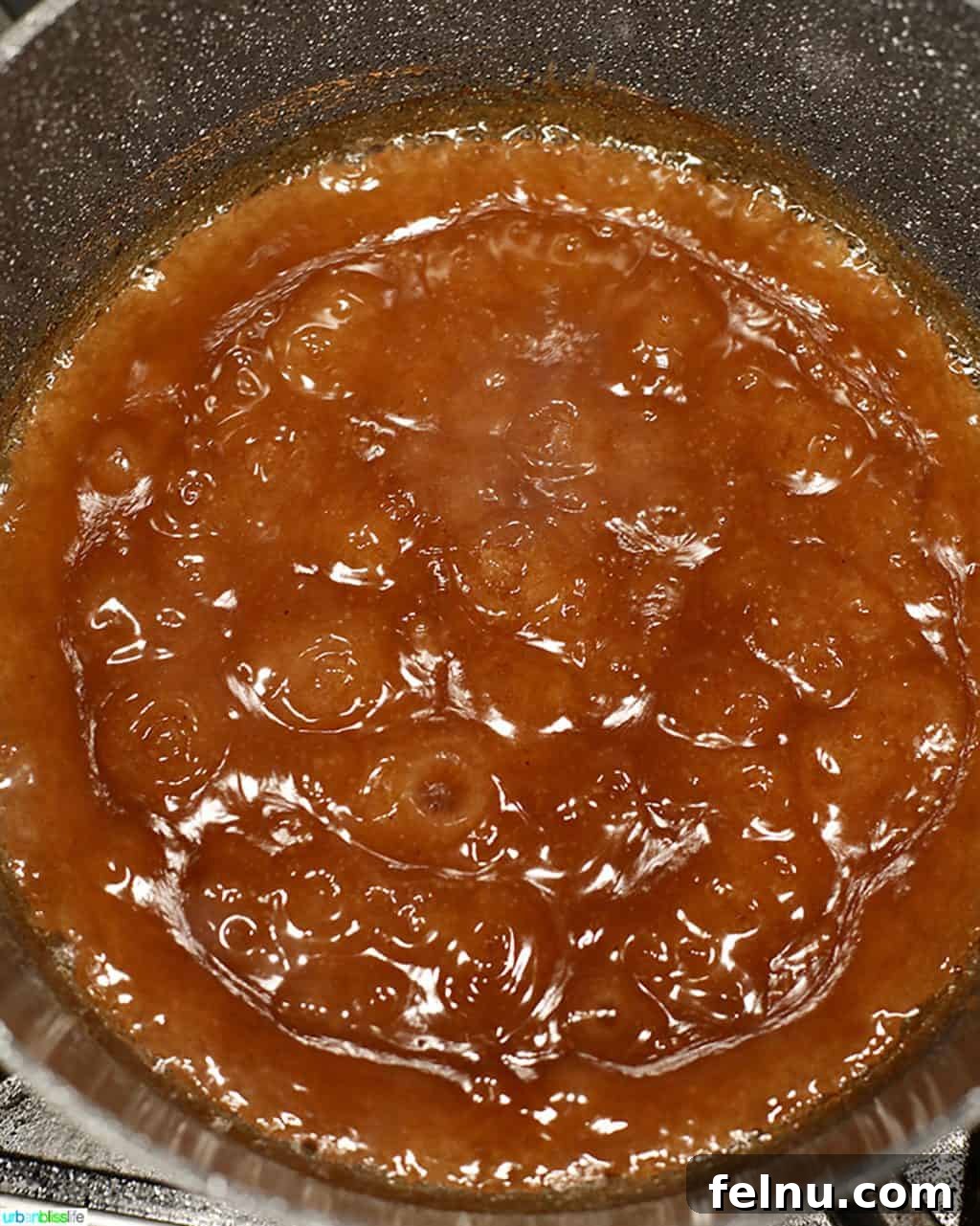 Homemade Freezer Apple Pie Filling 9 Apple pie filling liquid simmering and bubbling in a Dutch Oven on the stove