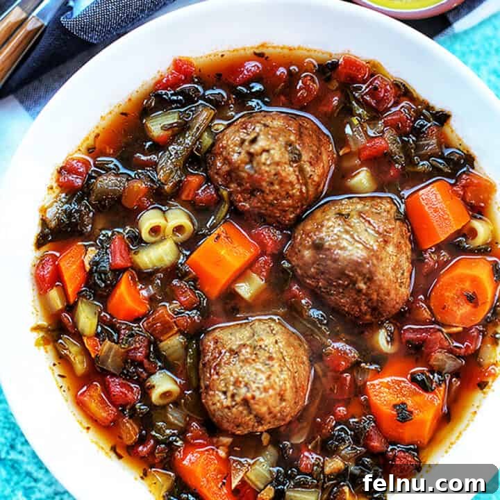 Hearty Slow Cooker Meatball Soup 8 Slow cooker meatball soup with carrots and pasta in a square image format.