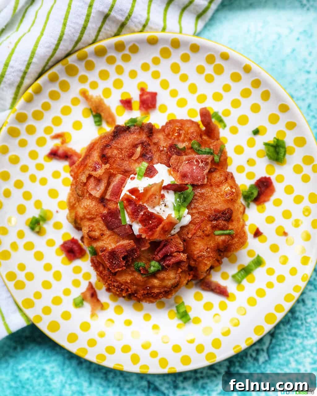 Golden Corn Fritters 11 A stack of freshly made, golden-brown corn fritters, ready for serving.