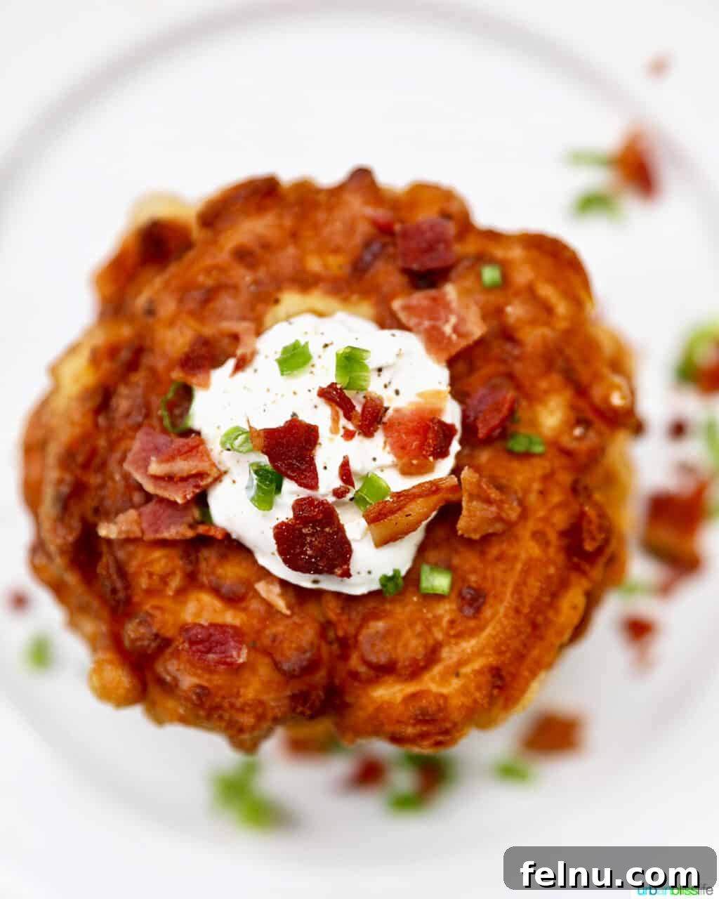 Golden Corn Fritters 12 Stack of corn fritters garnished with bacon bits and fresh green onions, tempting for any meal.