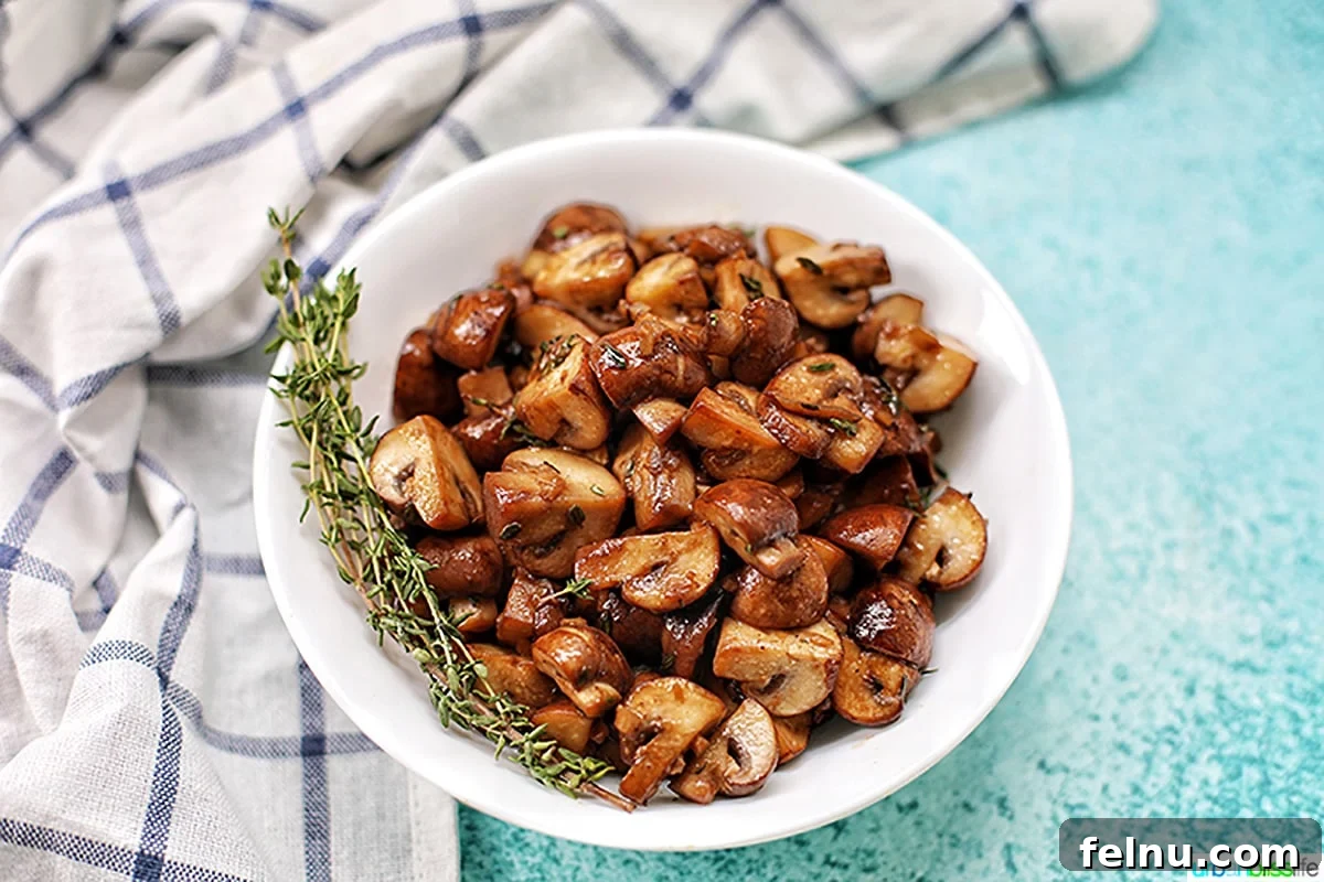 Savory Marsala Mushrooms 11 A generous bowl of mushroom marsala, presented on a blue background with a rustic kitchen towel, ready for a hearty meal