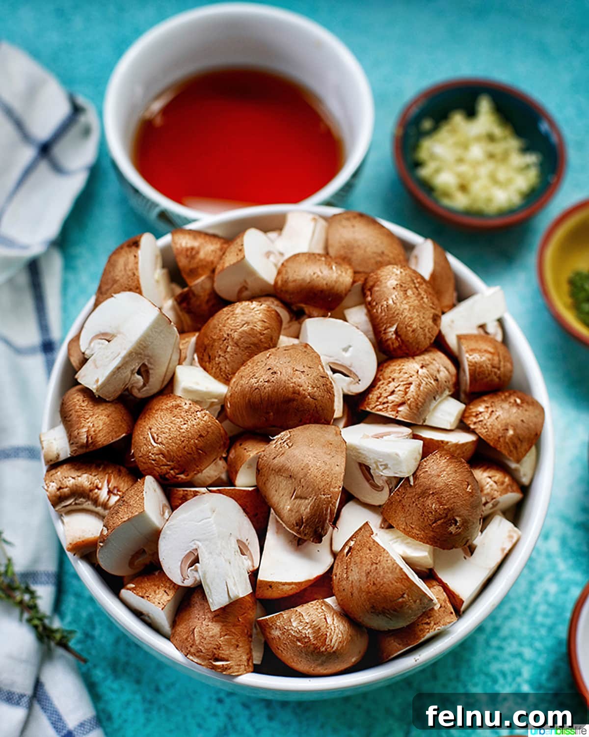 Savory Marsala Mushrooms 4 A bowl filled with freshly quartered cremini mushrooms, ready for cooking