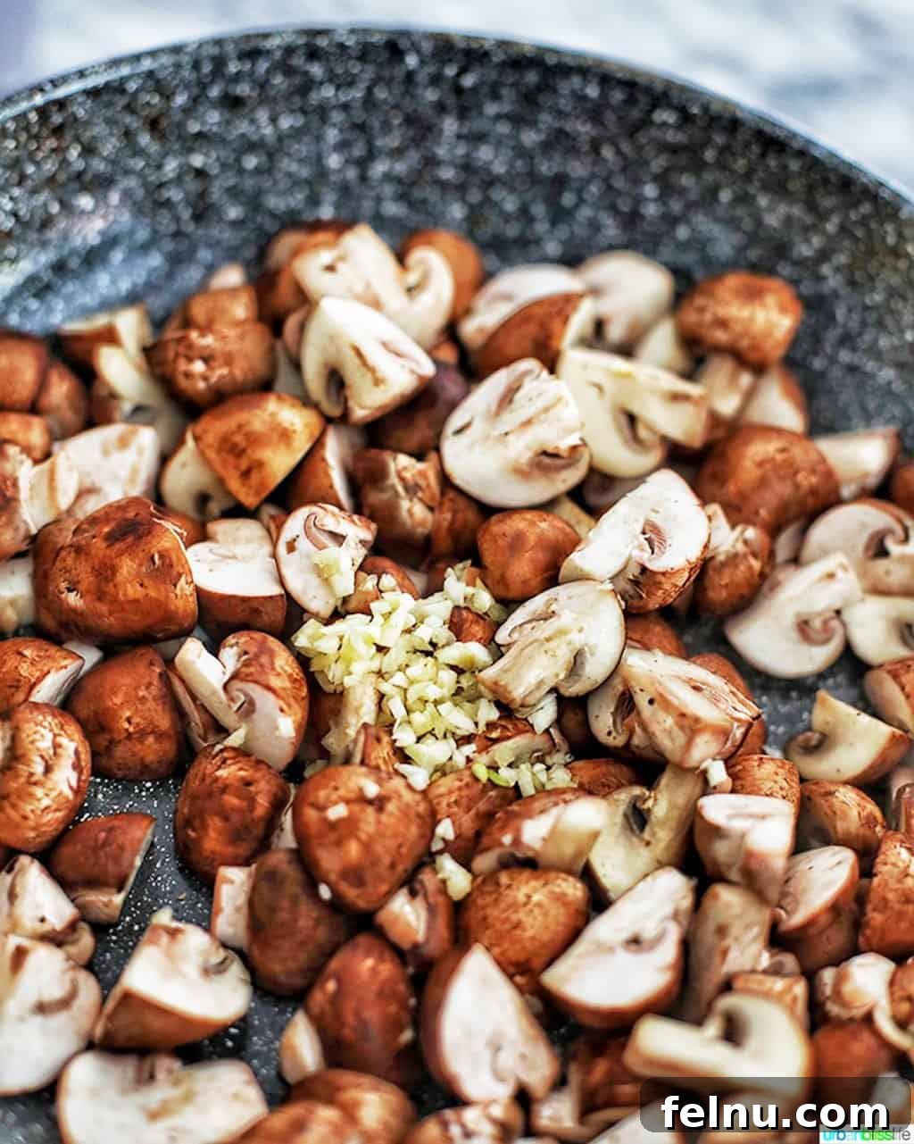 Savory Marsala Mushrooms 7 Mushrooms and minced garlic cooking together in a pan, releasing their combined aromatics