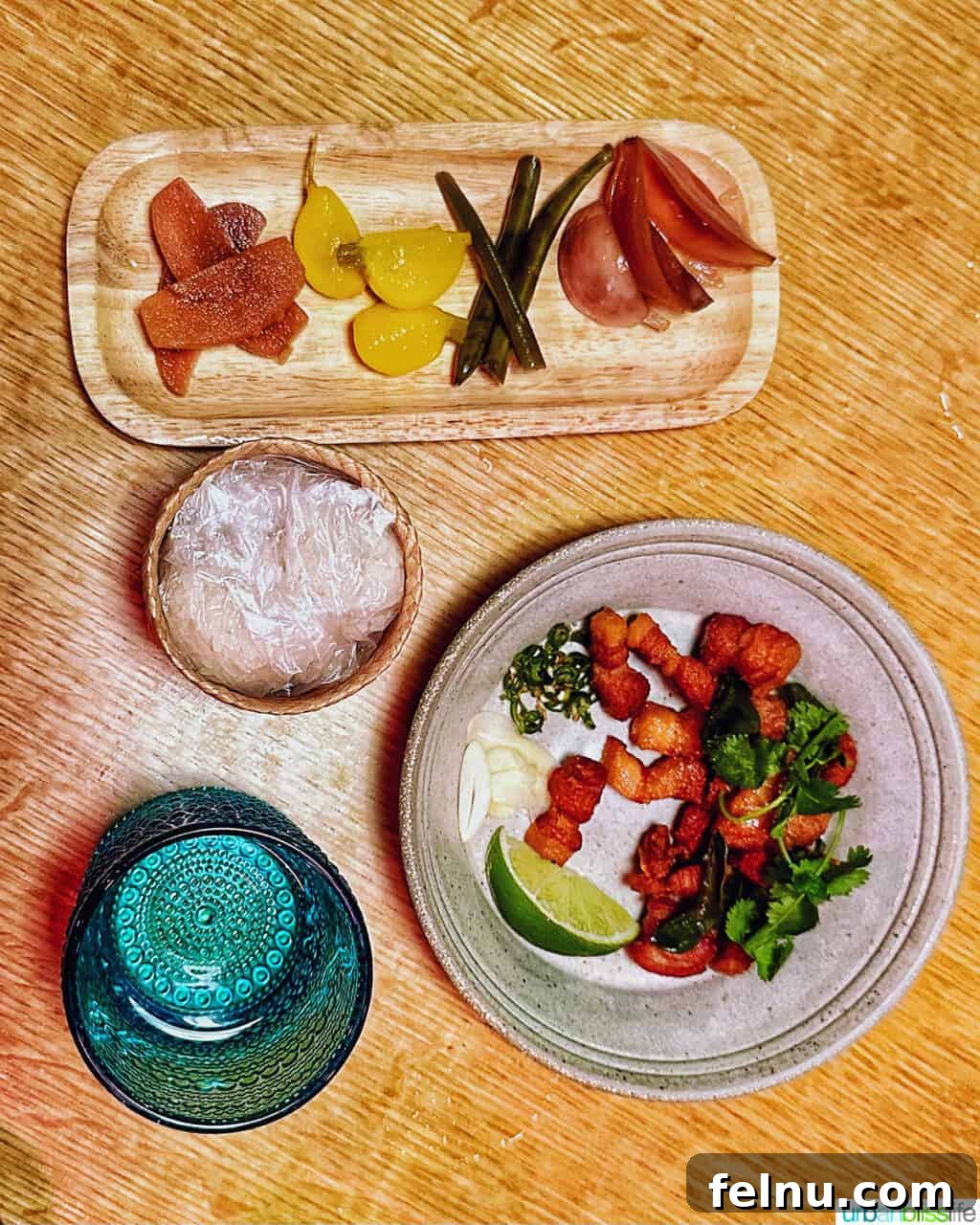 Portland's Top Romantic Dinner Spots 35 Assortment of pickled vegetables and a plate of crispy pork belly on a wood table at Phuket Cafe.