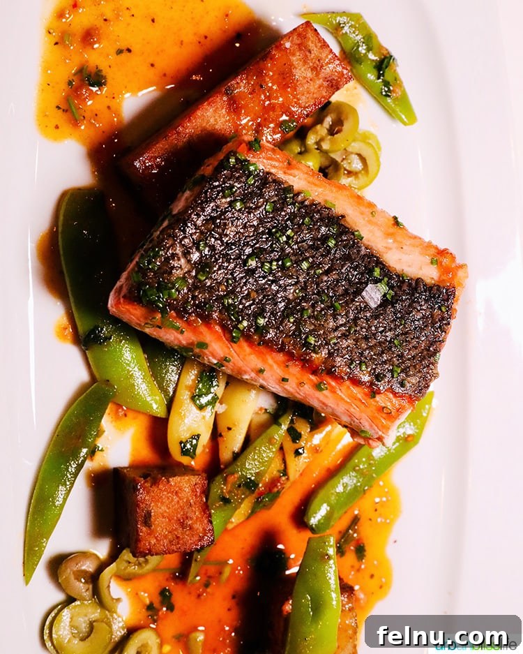 Portland's Top Romantic Dinner Spots 47 Flavorful salmon with crispy skin and fresh vegetables on a plate at RingSide Steak House in Portland, Oregon.
