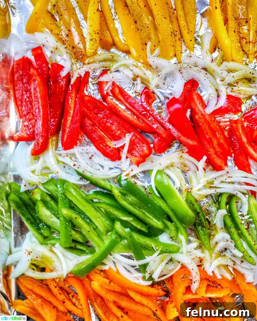 Sizzling Sheet Pan Chicken Fajitas 6 A colorful array of sliced bell peppers and onions, ready to be roasted to perfection and add a burst of flavor to the fajitas.