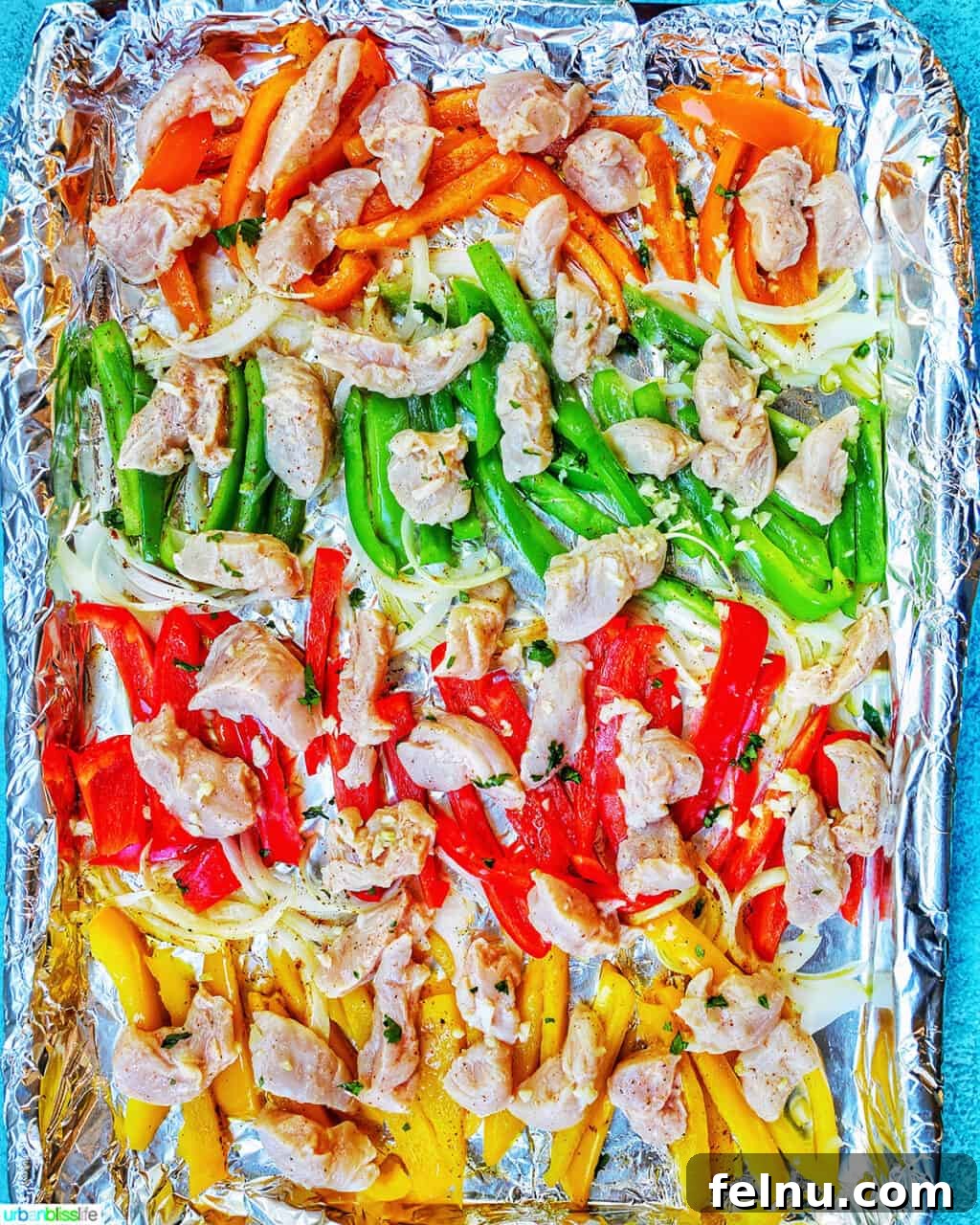 Sizzling Sheet Pan Chicken Fajitas 7 Sheet Pan Chicken Fajitas prepped and ready to be baked, showcasing the arranged chicken and vegetables on the baking sheet.