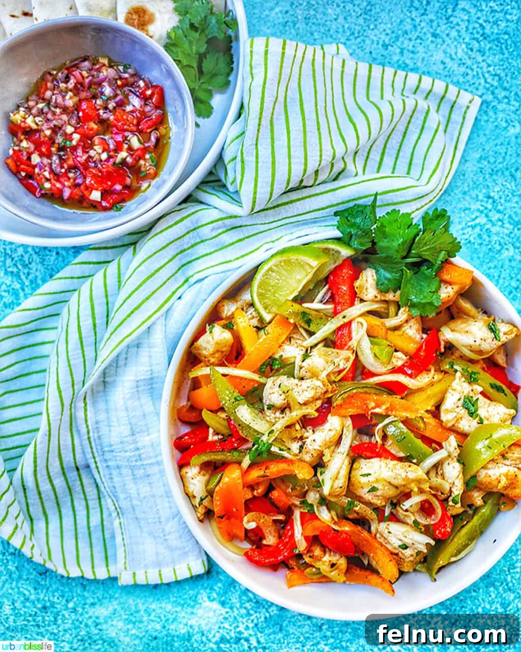 Sizzling Sheet Pan Chicken Fajitas 8 A large bowl of Sheet Pan Chicken Fajitas accompanied by fresh salsa, offering a glimpse of a complete and delicious meal.