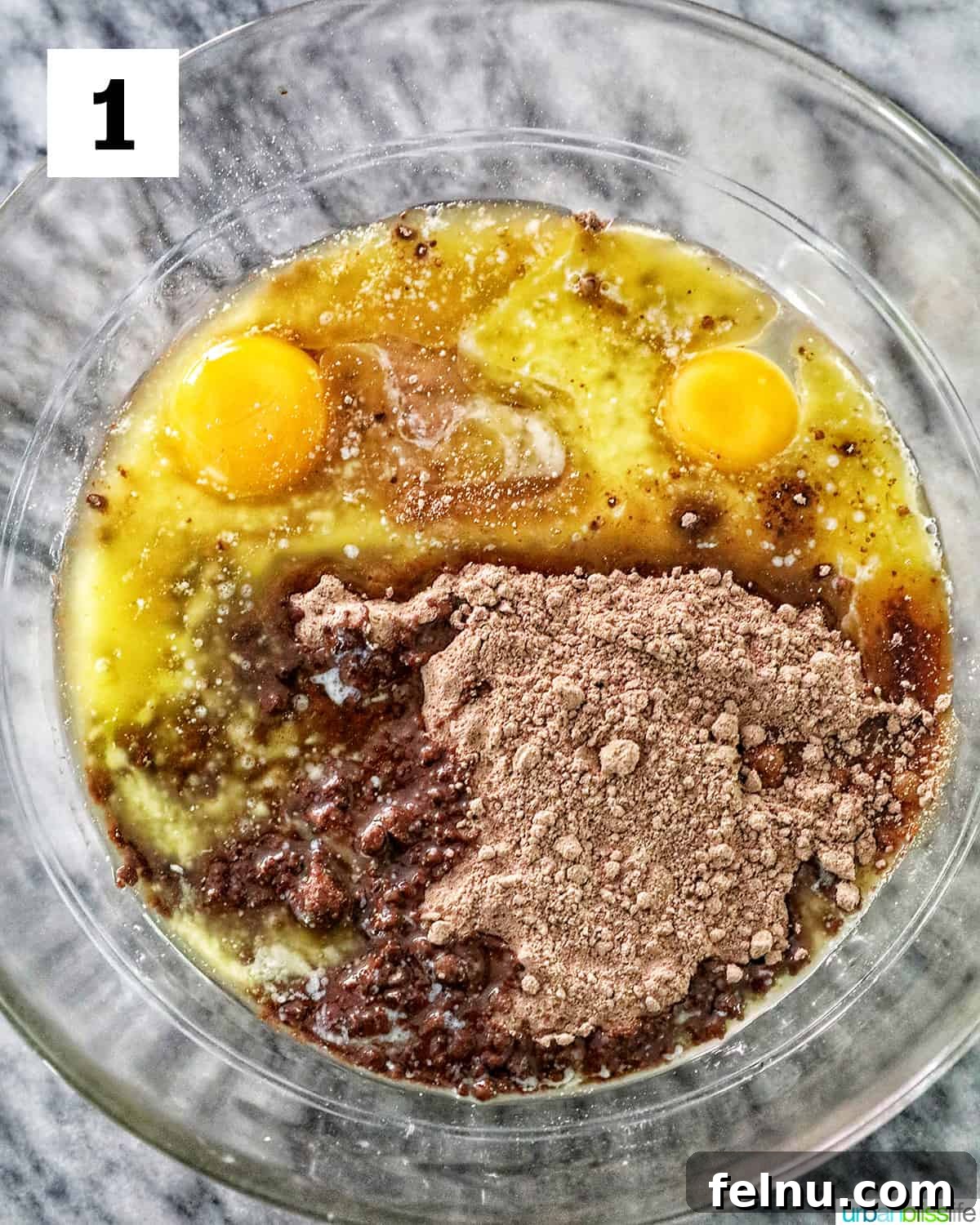 Chocolate Cake Mix Cookies 5 Eggs and chocolate cake mix in a glass bowl ready to be mixed.