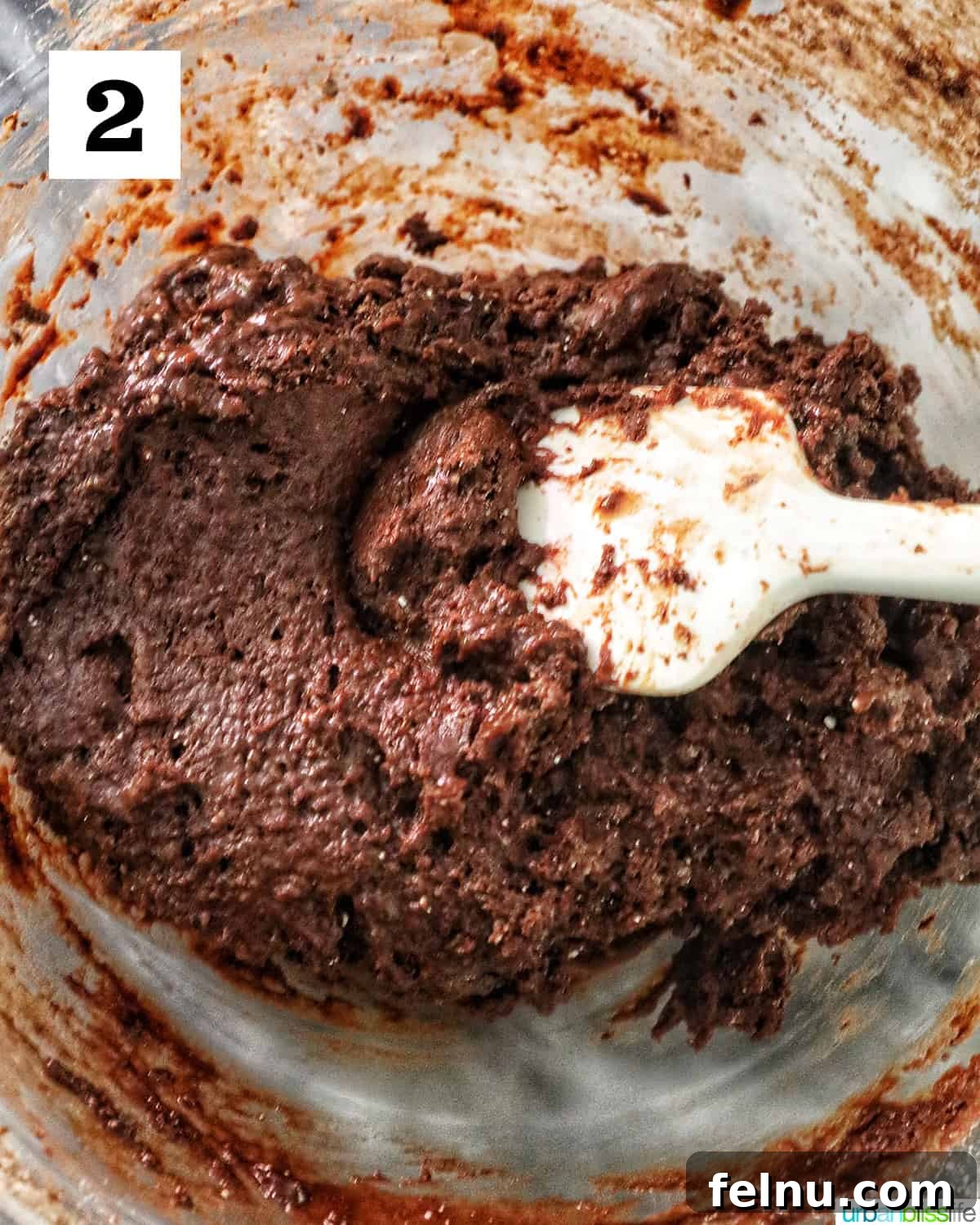Chocolate Cake Mix Cookies 6 Smooth chocolate cake mix cookie batter in a glass mixing bowl.