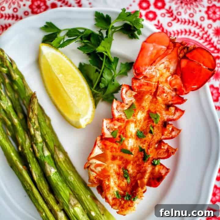 air fryer lobster tail with asparagus and lemon.