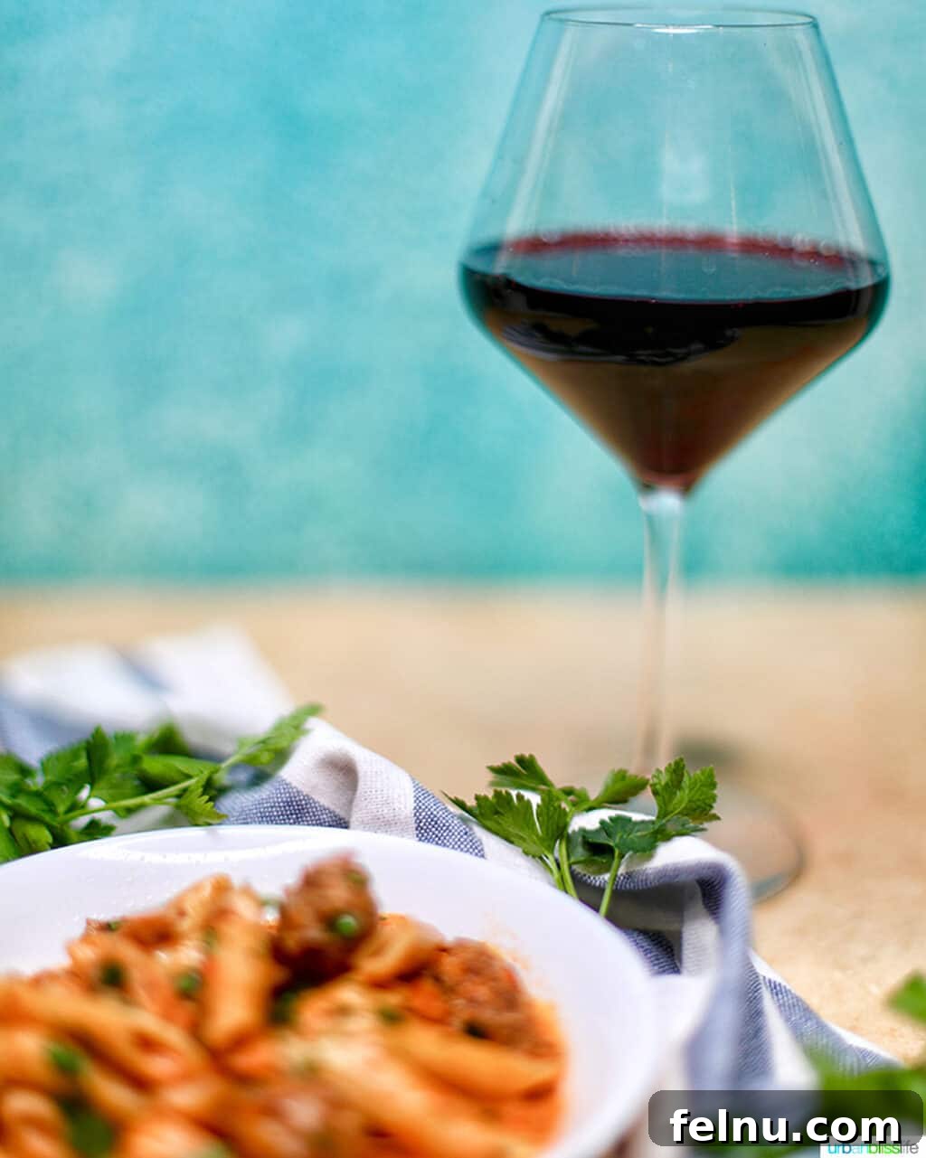 Cajun Chicken Pasta in a Flash 16 A glass of red wine alongside a steaming bowl of Ninja Foodi Cajun Chicken Pasta
