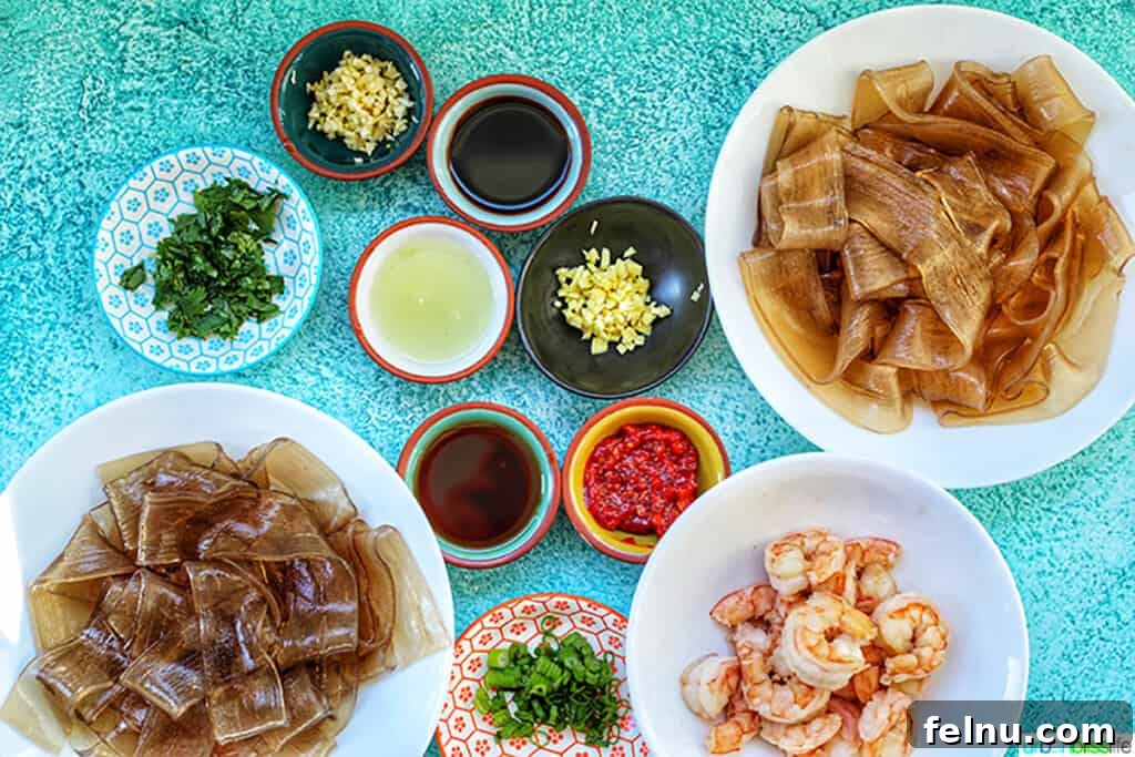Spicy Lime Shrimp Glass Noodle Bowl 4 ingredients for wide glass noodles with shrimp and chili lime oil sauce laid out on a table