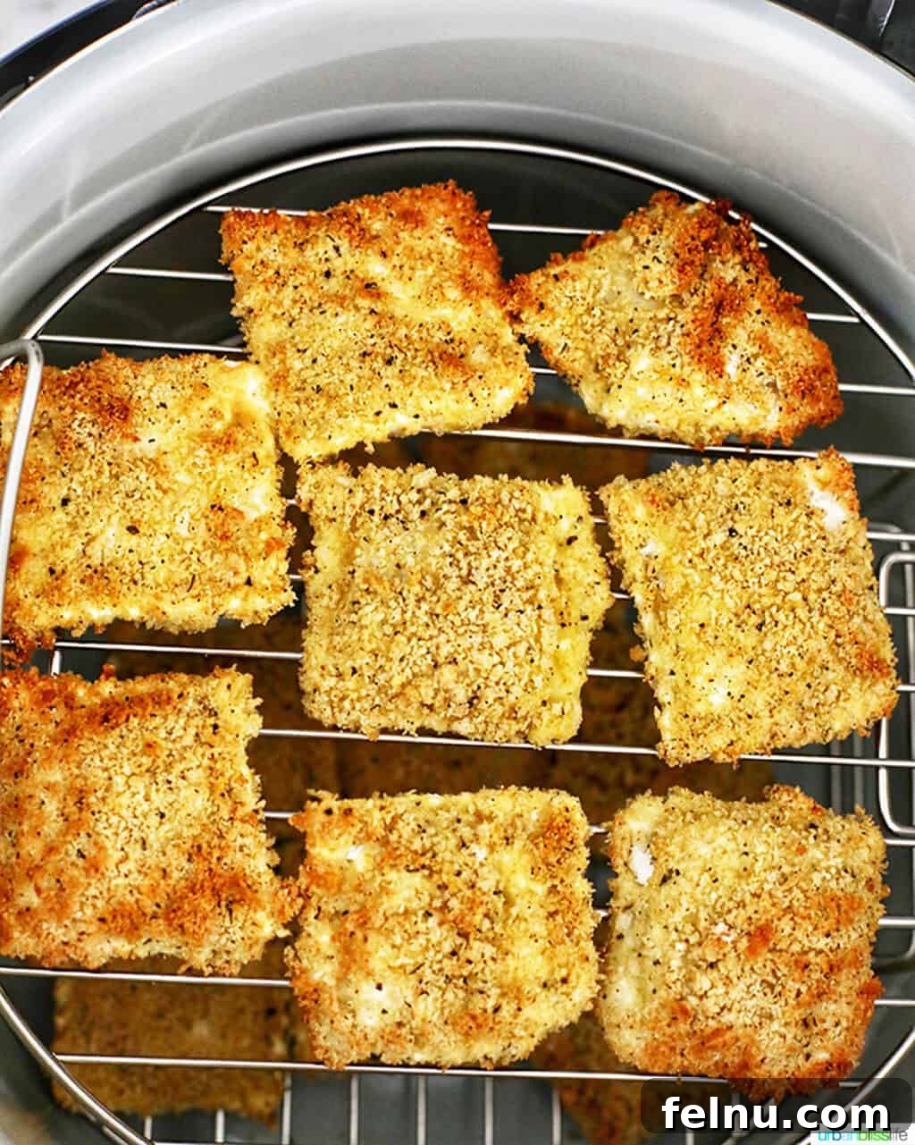 Air Fryer Ravioli Bites 8 Perfectly air-fried ravioli, golden brown and crispy, in the Ninja Foodi.
