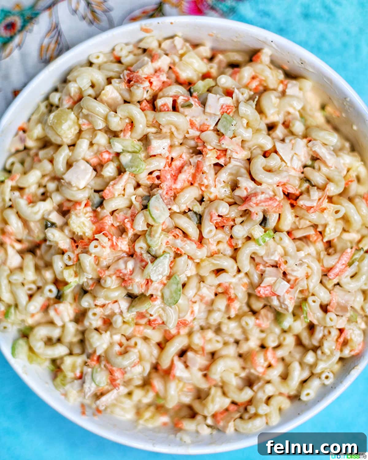 Filipino-Style Macaroni Salad 11 Filipino Macaroni Salad - macaroni, carrots, chicken, celery, pineapple, sliced hard-boiled egg- in a bowl.