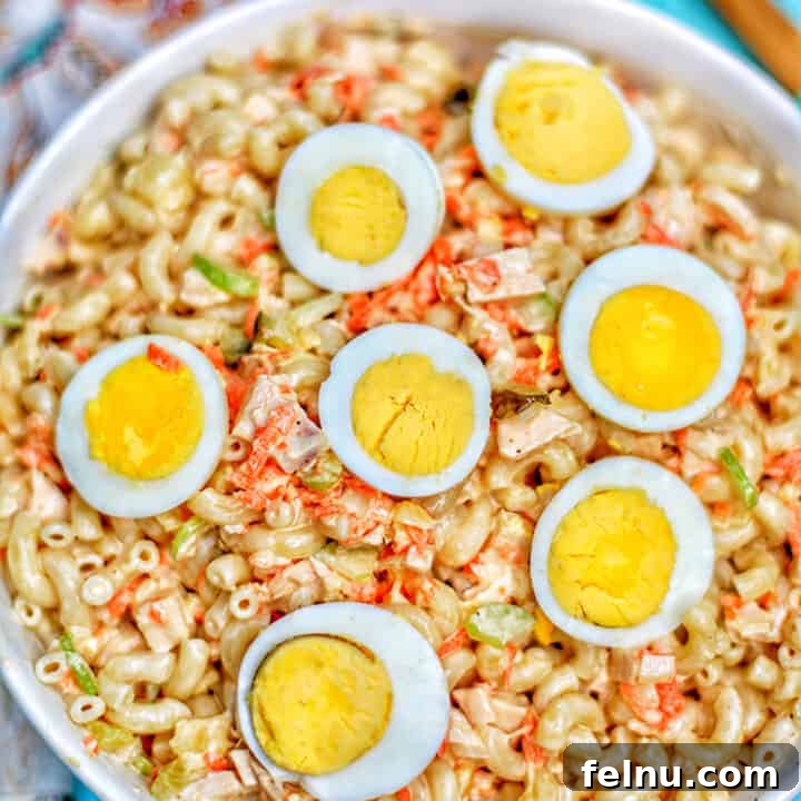 filipino macaroni salad with hard boiled egg halves in bowl.