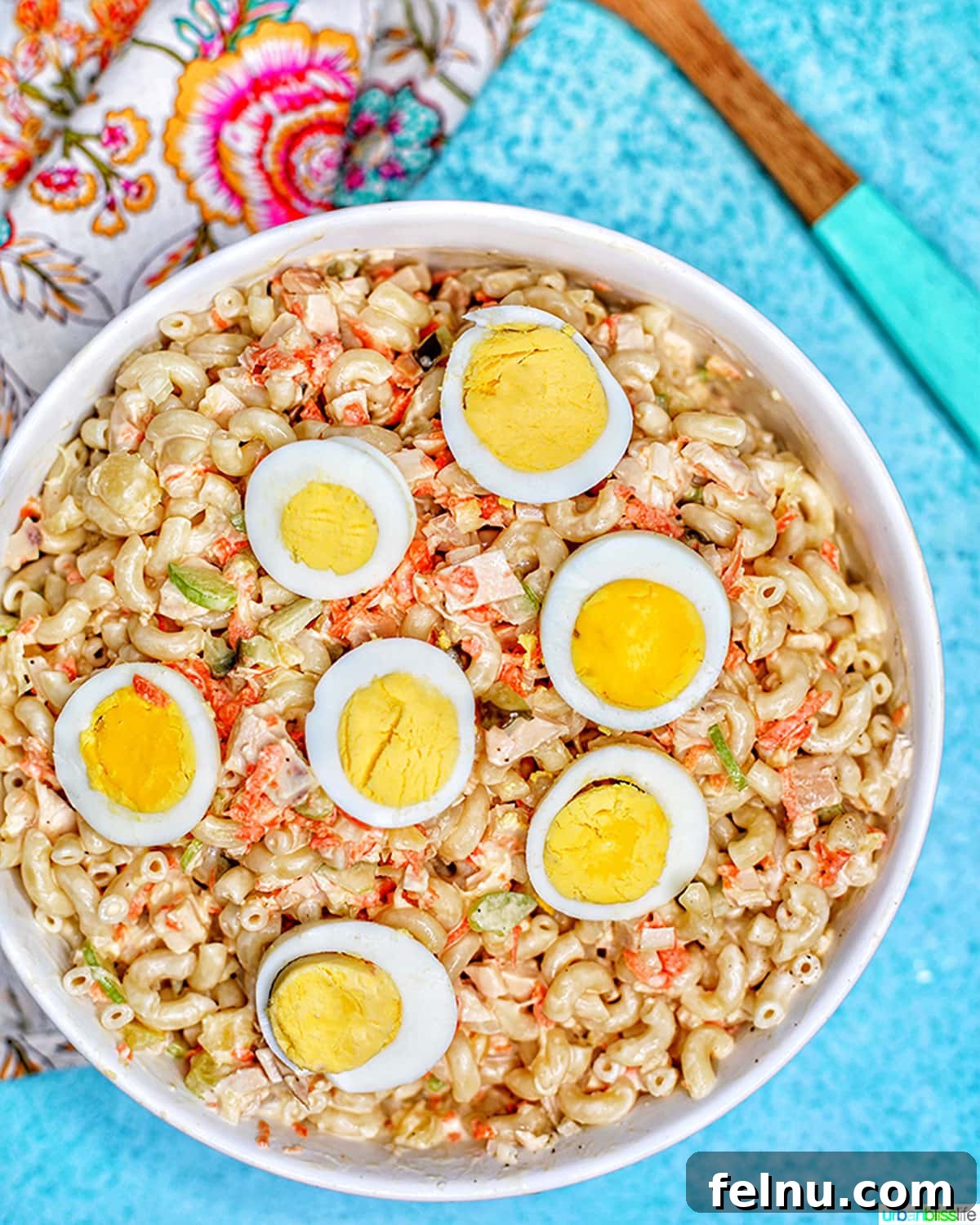 Filipino-Style Macaroni Salad 3 Filipino Macaroni Salad - macaroni, carrots, chicken, celery, pineapple, sliced hard-boiled egg- in a bowl.