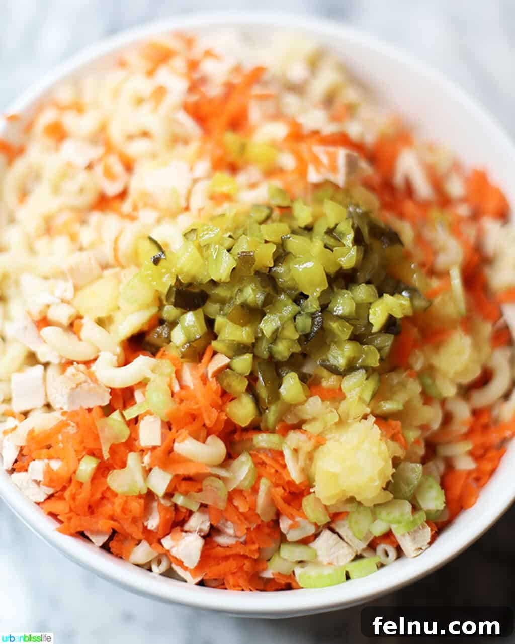 Filipino-Style Macaroni Salad 9 ingredients for Filipino Macaroni Salad mixing in bowl