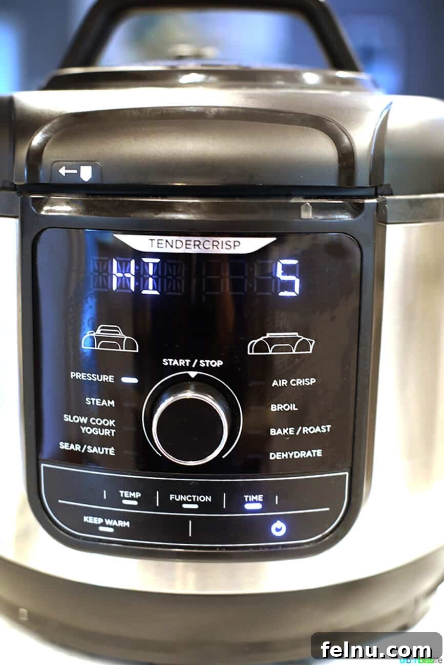 Perfect Hard Boiled Eggs with Ninja Foodi 5 Ninja Foodi display showing pressure cook HI for 5 minutes