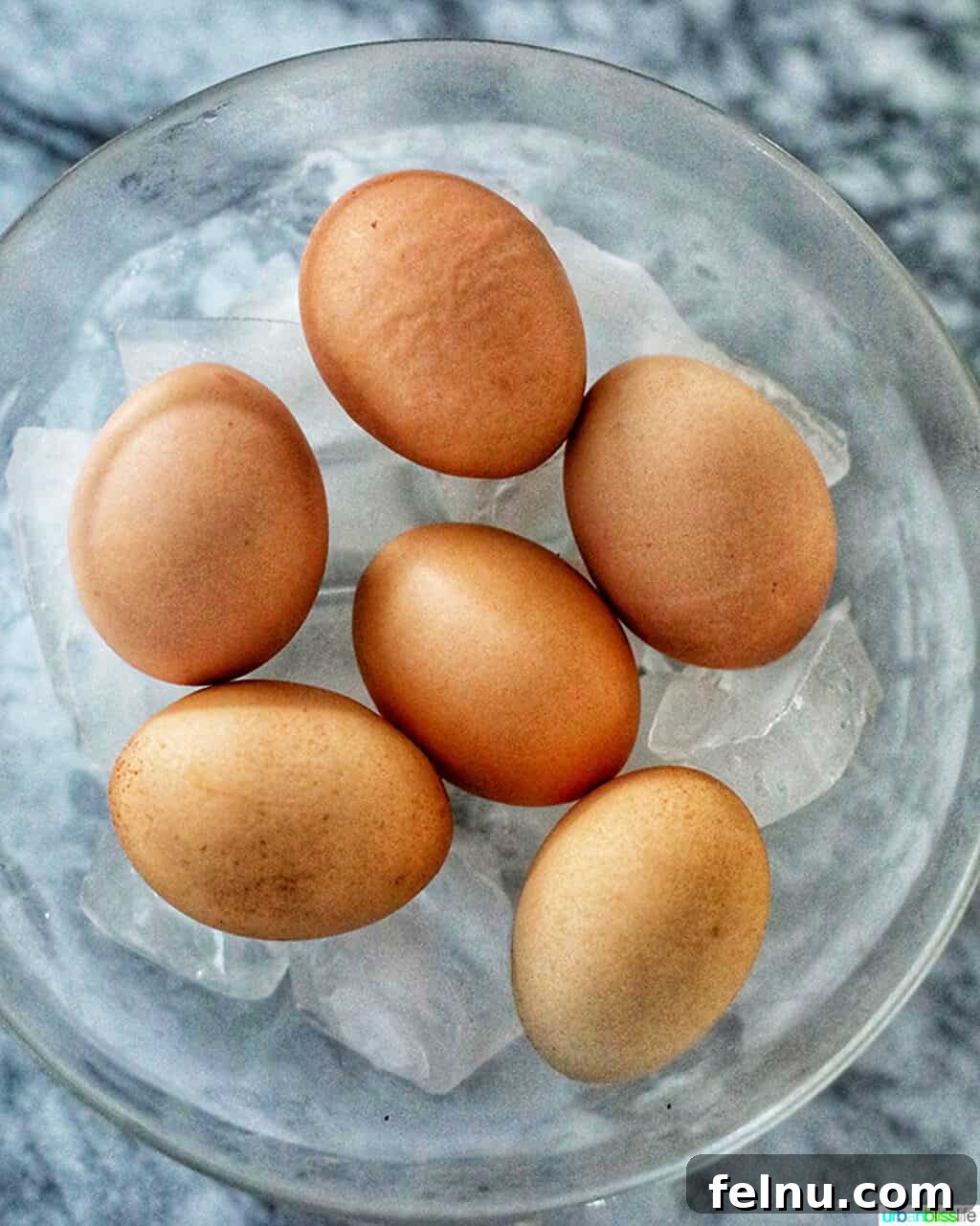 Perfect Hard Boiled Eggs with Ninja Foodi 6 Hot hard-boiled eggs being immediately placed into an ice bath