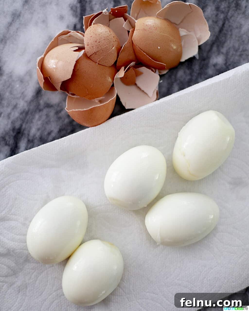 Perfect Hard Boiled Eggs with Ninja Foodi 8 Perfectly peeled hard-boiled eggs, showcasing smooth whites