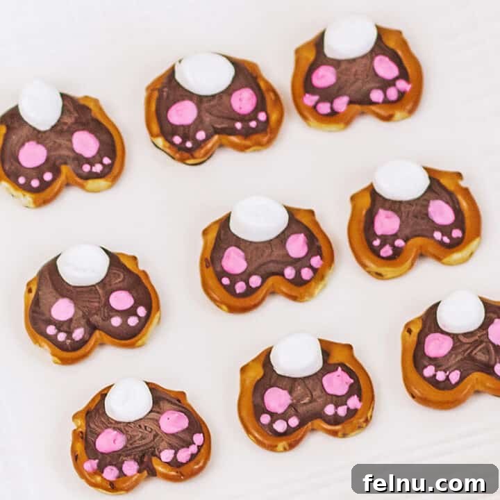 Pretzel bunny bottoms with white and pink icing, decorated for Easter.