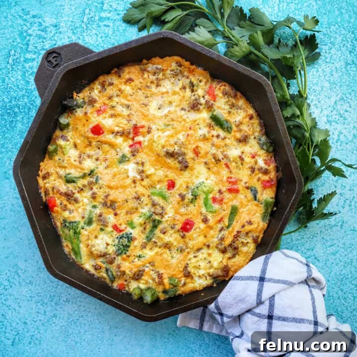 sausage frittata with spring vegetables in cast iron skillet.