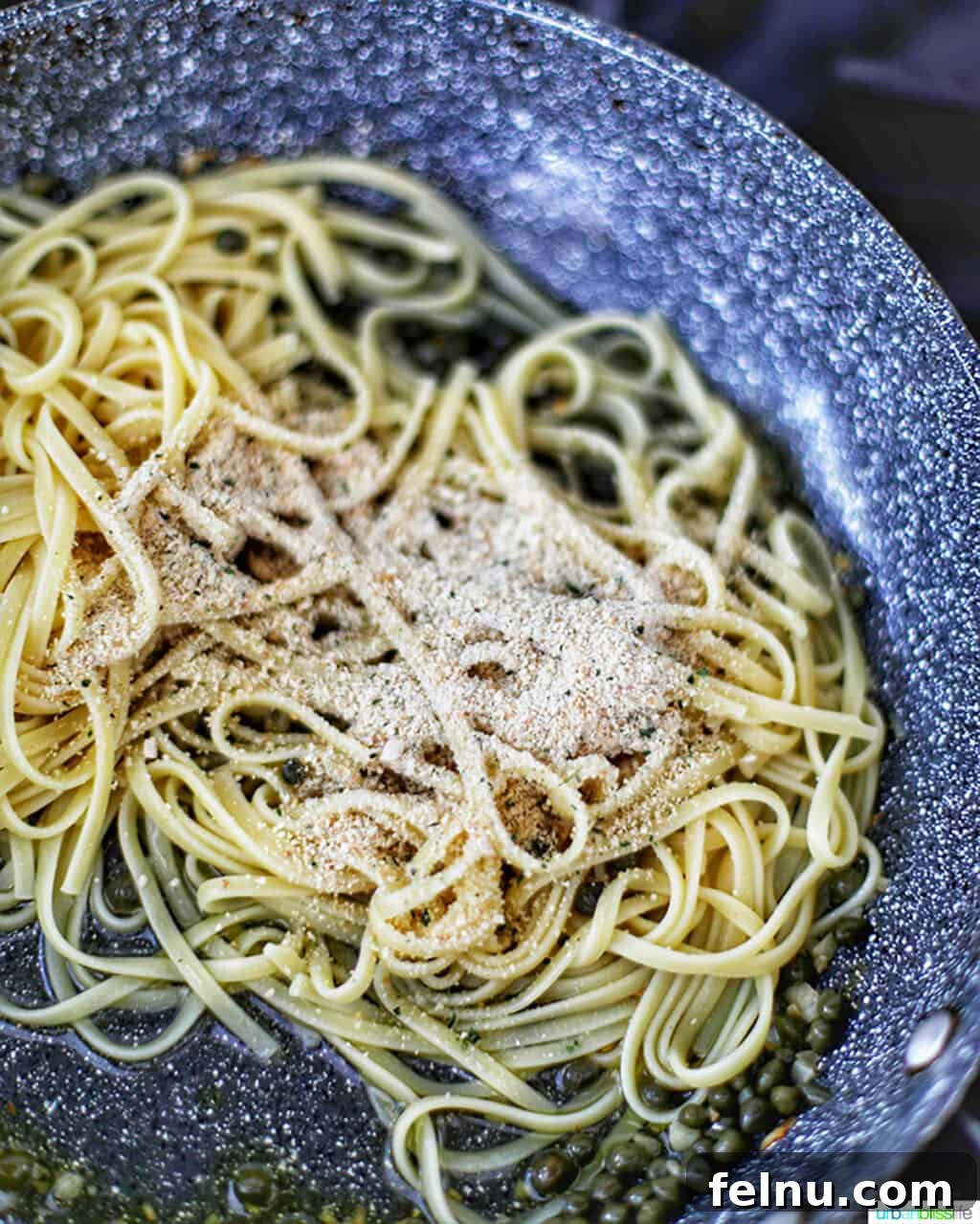 Tuna Pasta in Creamy Caper White Wine Sauce 7 Adding pasta to the sauce in skillet