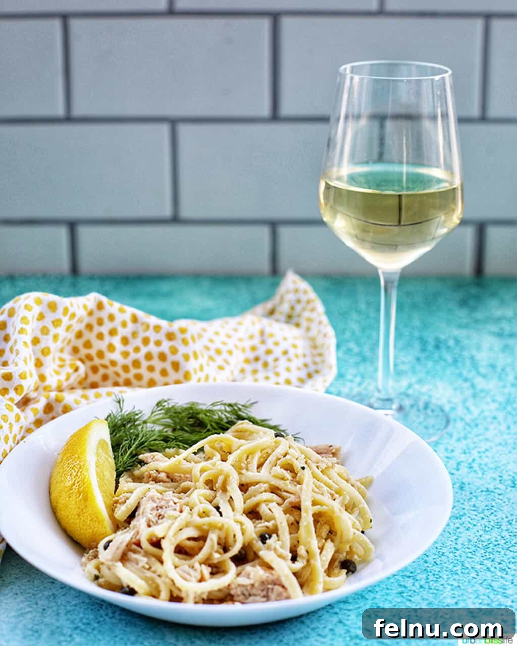 Tuna Pasta in Creamy Caper White Wine Sauce 9 Glass of white wine with bowl of tuna pasta